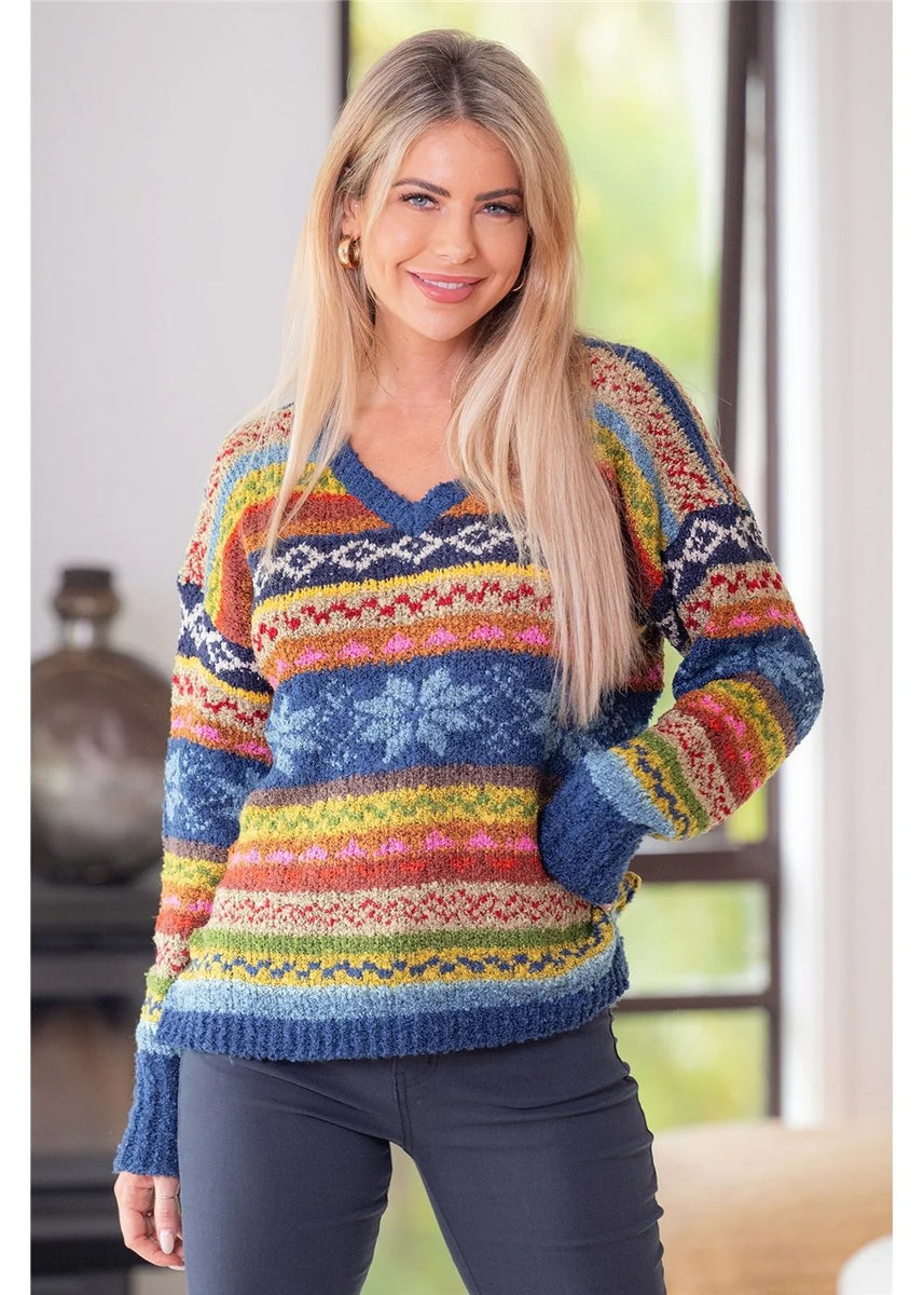 Woman wearing a colorful patterned sweater indoors